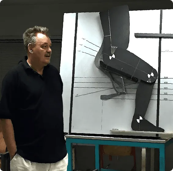 Our designer looking at a model of our patented T-Mech Mechanism in action.