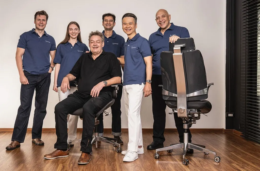A group portrait of seven team members standing together outside, all wearing matching navy blue polo shirts and smiling.