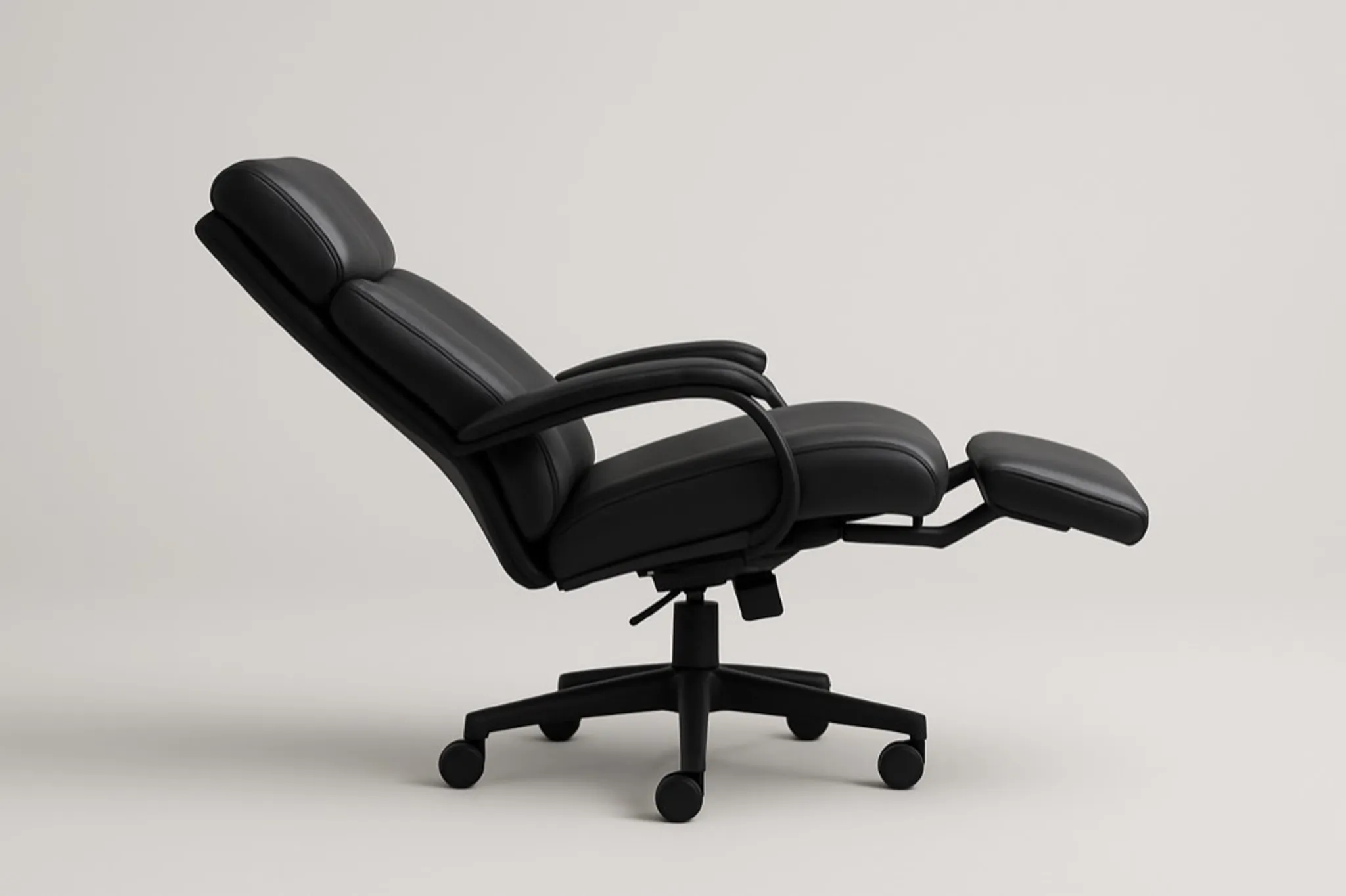 A person reclined in a zero-gravity chair beside the same person upright and typing in an ergonomic task chair