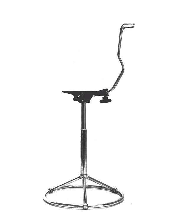 Early chair prototype with an exposed back support and circular footrest