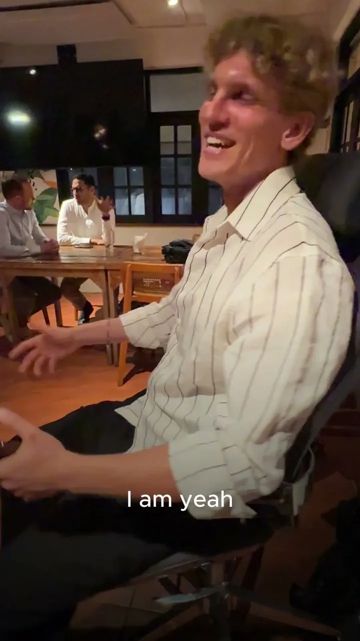 A man in a striped shirt seated in the Vision Chair