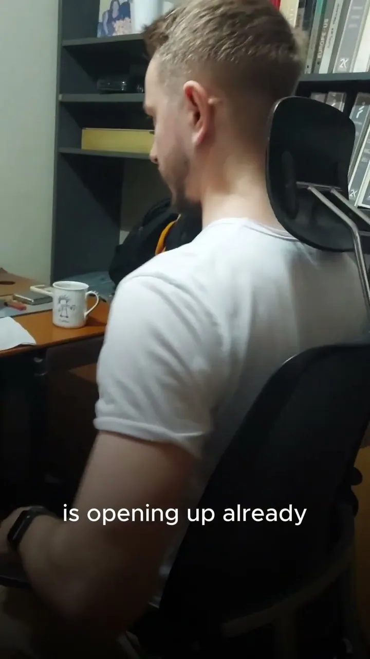 A man seated at a desk in the Vision Chair