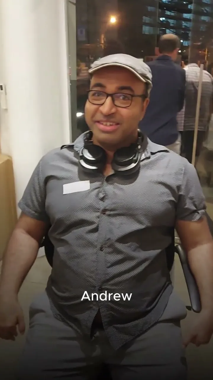 A man with headphones around his neck seated in Vision