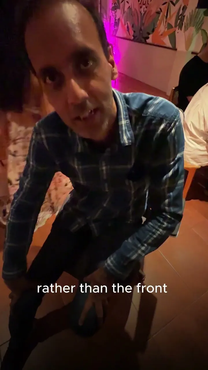 A man in a checked shirt seated in Vision