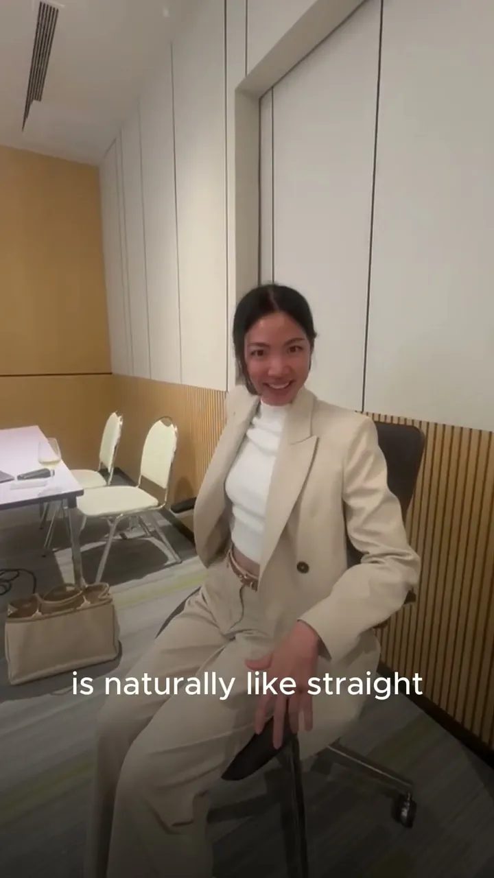 A woman in a light suit seated in the Vision Chair