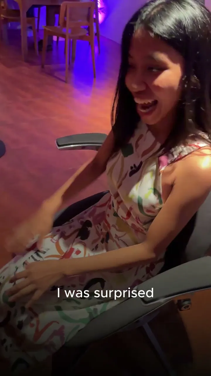A woman in a patterned dress seated in Vision