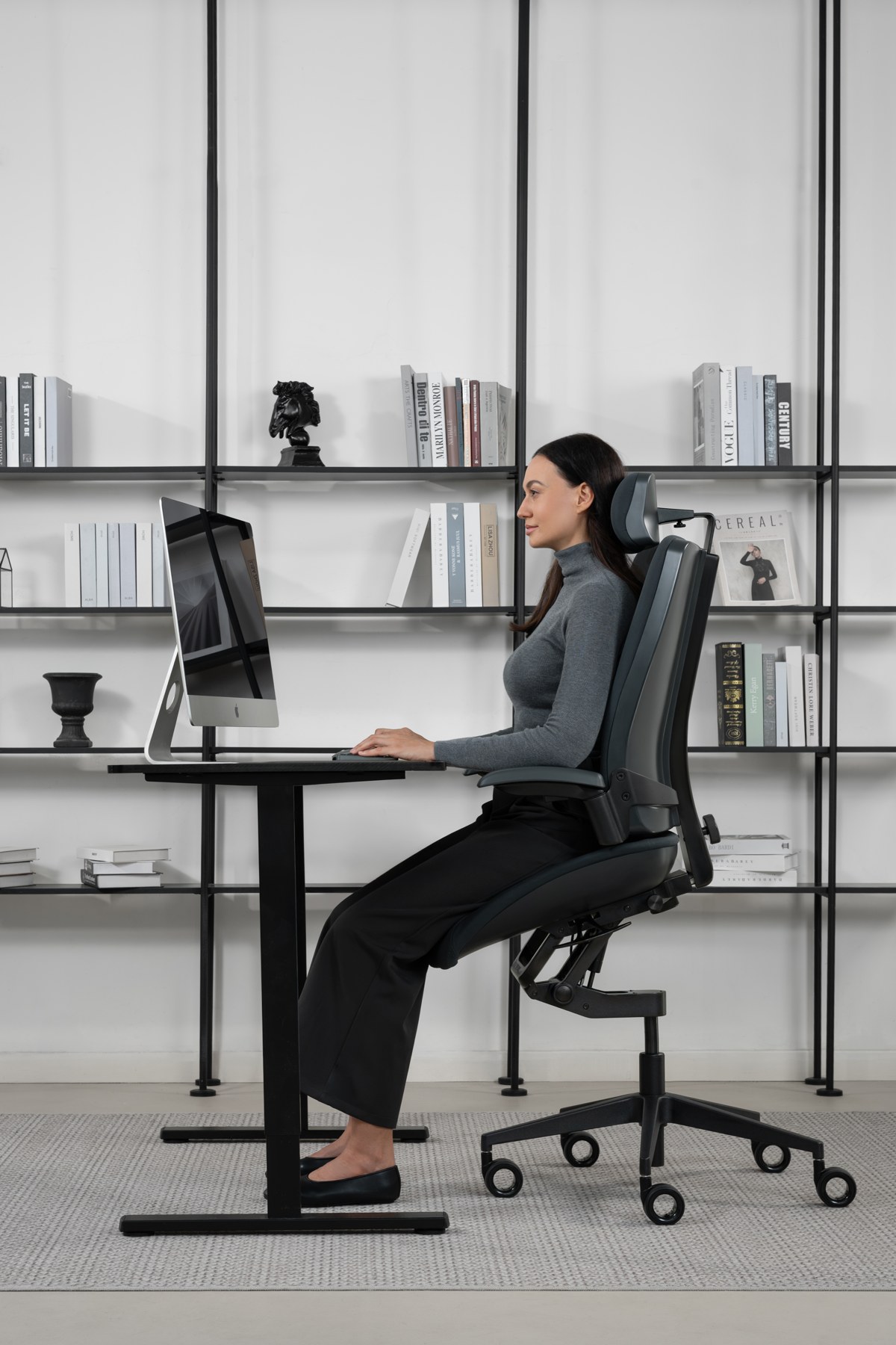 Woman using Vision in an elevated position at a height-adjustable desk