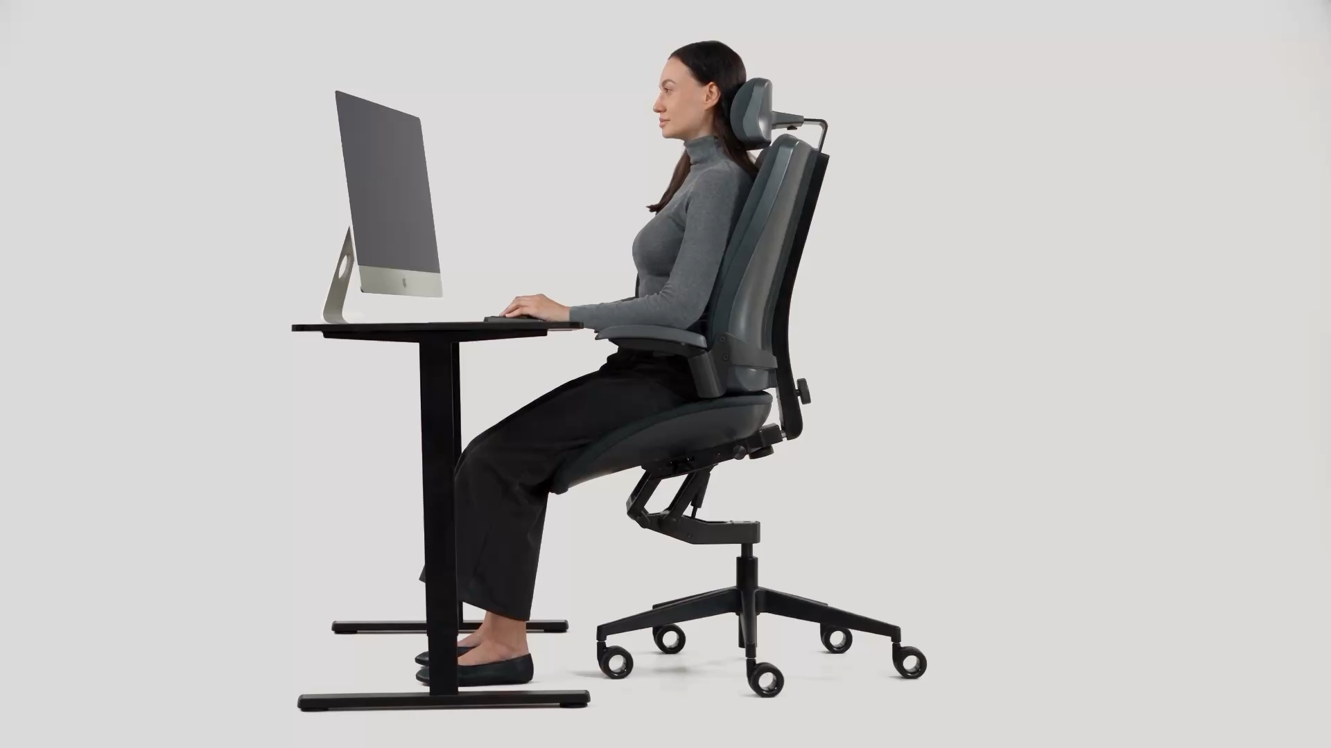 Woman using Vision in an elevated position at a height-adjustable desk