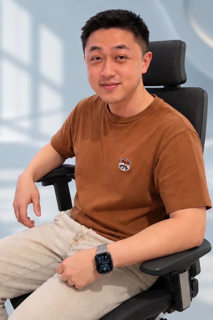 A man in a brown shirt seated in Vision